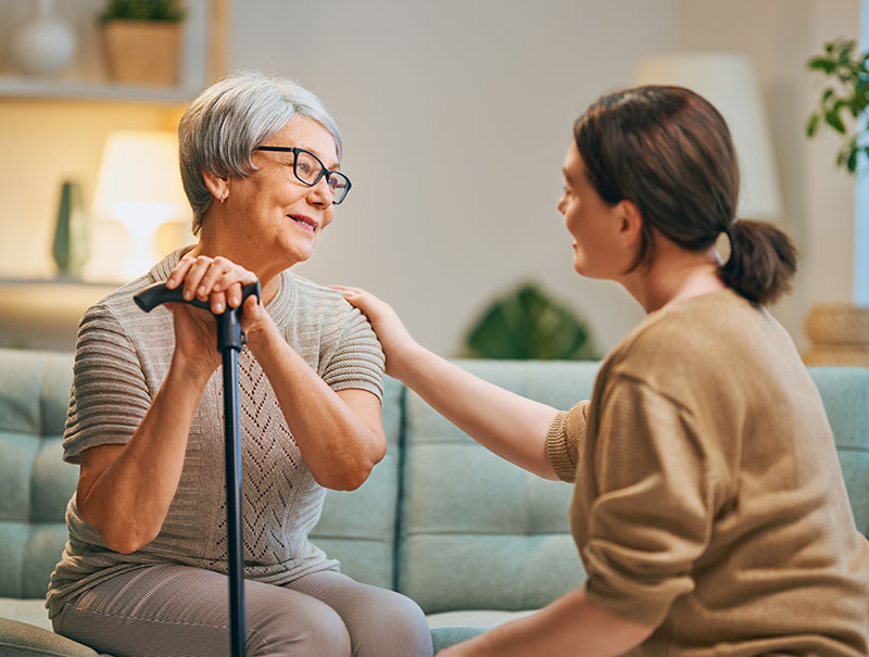 Caregiver and senior talking in home